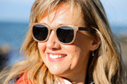 Made with sustainable speckled charcoal wheat straw or coffee residue frame and walnut wood temples, these stylish shades are lightweight, comfortable and eco-friendly with their plastic alternative materials. Fitted with UV400 polarised lenses in a smoke black colour and subtle logo is engraved on the temples. Sunglasses come with a padded pouch and microfibre cleaning cloth. 