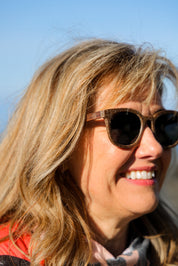 Made with sustainable speckled charcoal wheat straw or coffee residue frame and walnut wood temples, these stylish shades are lightweight, comfortable and eco-friendly with their plastic alternative materials. Fitted with UV400 polarised lenses in a smoke black colour and subtle logo is engraved on the temples. Sunglasses come with a padded pouch and microfibre cleaning cloth. 